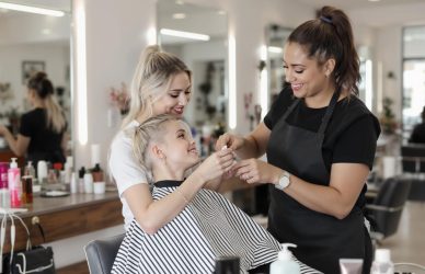 Fresher beautician learning under a senior stylist in a salon — ideal for promoting entry-level job opportunities in the beauty industry.