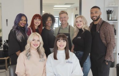 Hair stylist working with a male and female client in a modern unisex salon — perfect for showcasing gender-inclusive salon job vacancies.