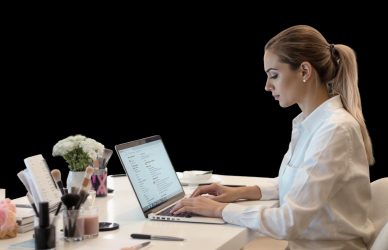 Beauty professional creating a resume on a laptop — ideal for promoting a free resume generator for salon and spa candidates.