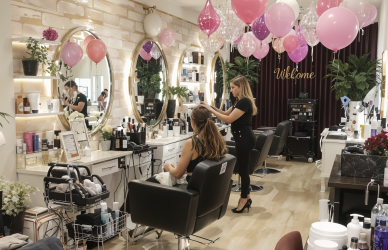 Salon owner setting up a beauty salon with staff, equipment, and welcoming decor for a grand opening